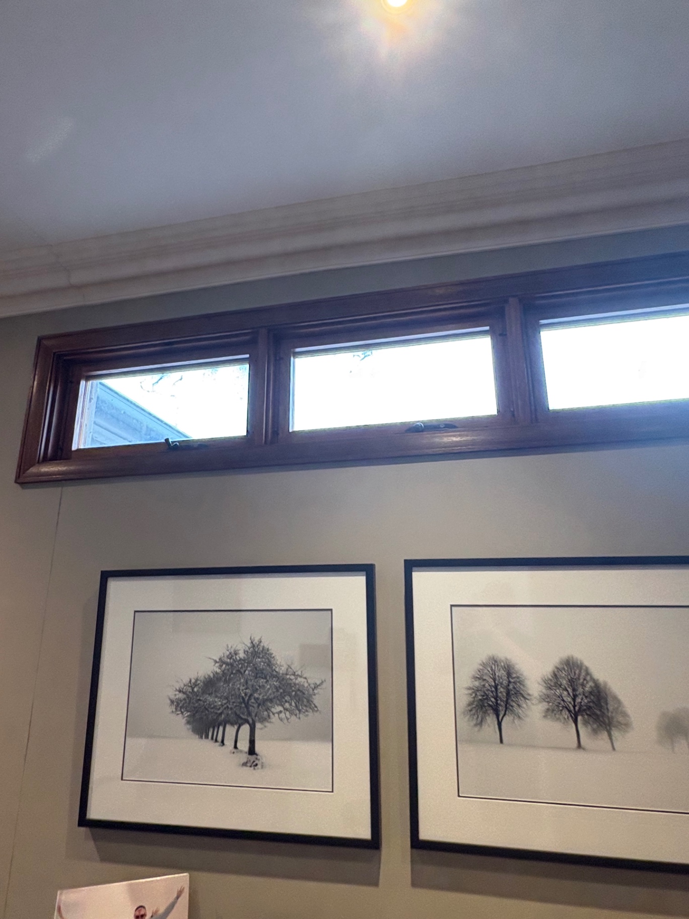 Timber-framed highlight windows above the artwork